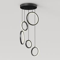 The Artika Elmo 5-light LED pendant features five black rings in varying sizes, each suspended at different heights with built-in LED lights along their inner edges. Adjustable CCT offers versatile modern lighting for any space.