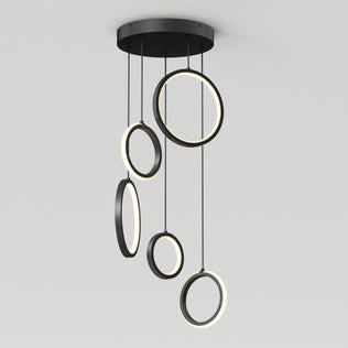 The Artika Elmo 5-light LED pendant features five black rings in varying sizes, each suspended at different heights with built-in LED lights along their inner edges. Adjustable CCT offers versatile modern lighting for any space.