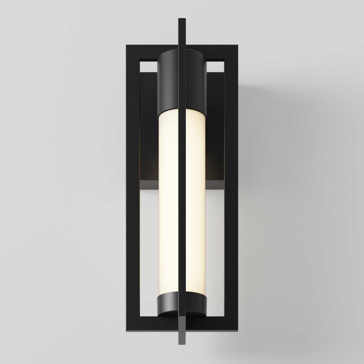 A modern wall sconce with a black rectangular frame and a cylindrical white frosted glass light, mounted vertically against a plain light gray wall.