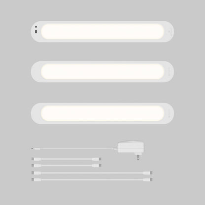 Artika Impulse Under-Cabinet LED Light RGB+CCT set with remote, adapter, and four connectors on a gray background.