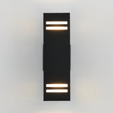A modern, rectangular black wall sconce with two horizontal light strips at both the top and bottom, mounted on a white wall and emitting a soft glow.
