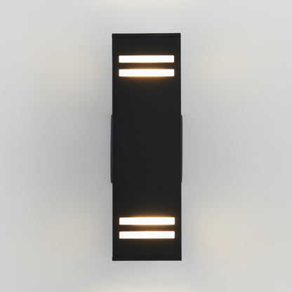 The Artika Strike indoor-outdoor wall light is a modern black sconce with horizontal light strips on the top and bottom, mounted on a white wall and casting soft, warm light both upward and downward.