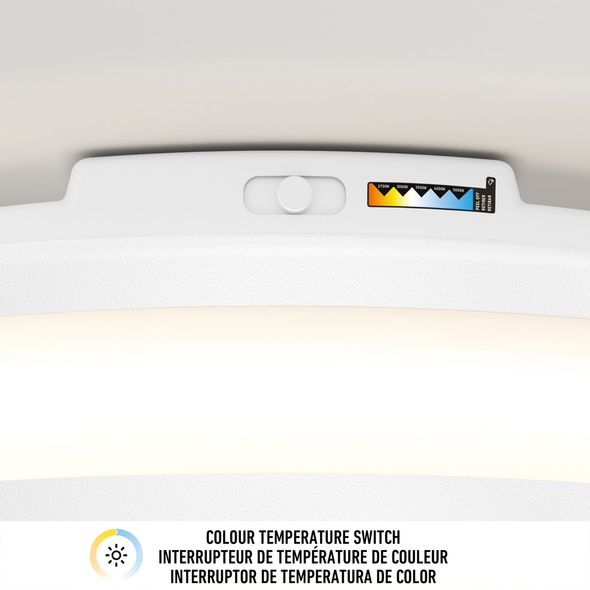 Close-up of the color temperature slider on Artika's Hemisphere 15 in. LED flush mount light, showing five CCT ranges with colored triangles and a COLOUR TEMPERATURE SWITCH label in three languages.