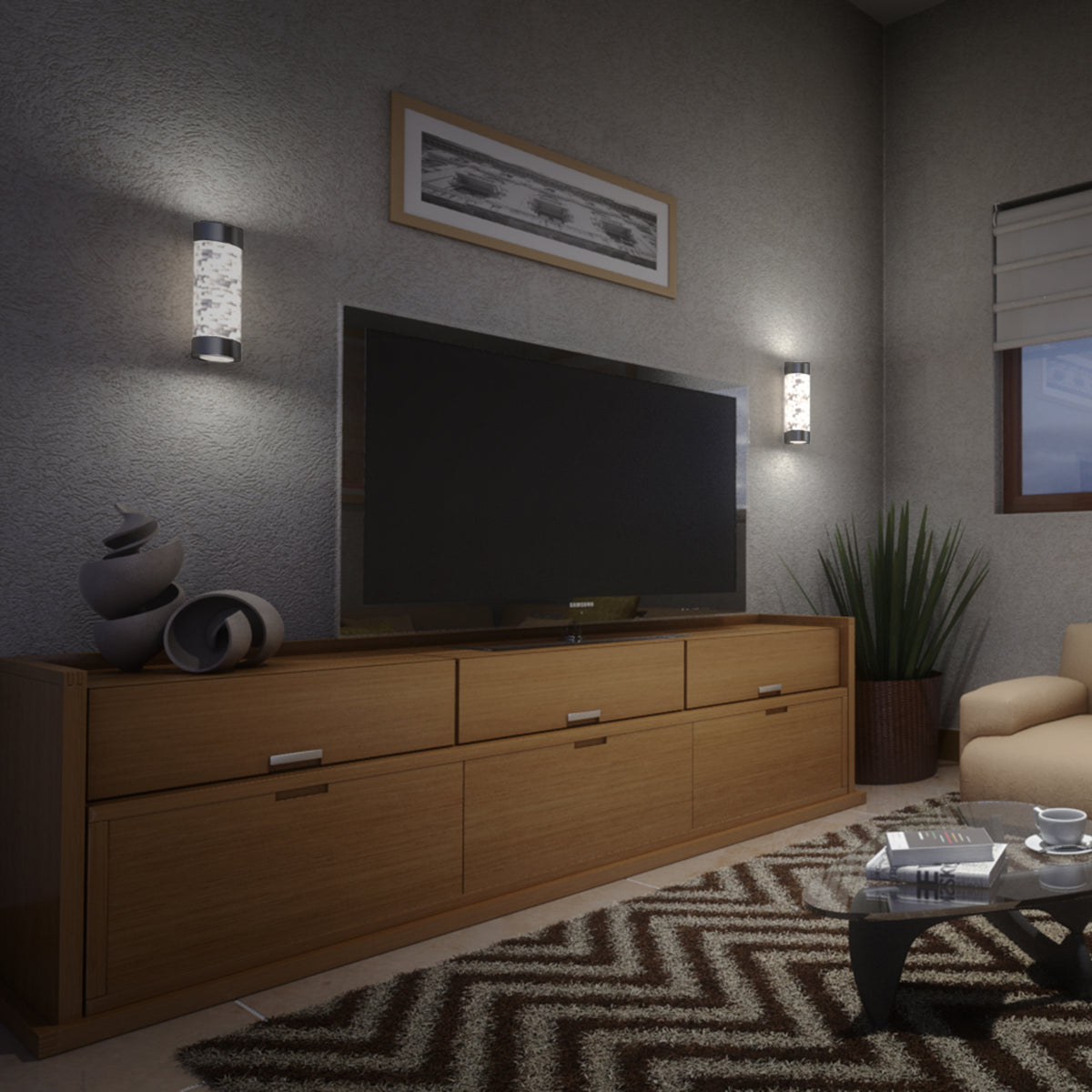 A modern living room with a large flat-screen TV on a wooden cabinet, abstract decor pieces, zigzag-patterned rug, glass coffee table, potted plant, beige armchair, and wall-mounted lights.