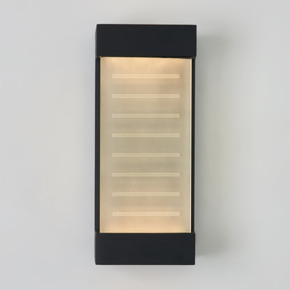 The Percy LED indoor-outdoor wall light by Artika features a rectangular design with a frosted glass panel and horizontal etched lines, framed by black metal top and bottom edges, mounted on a white wall.
