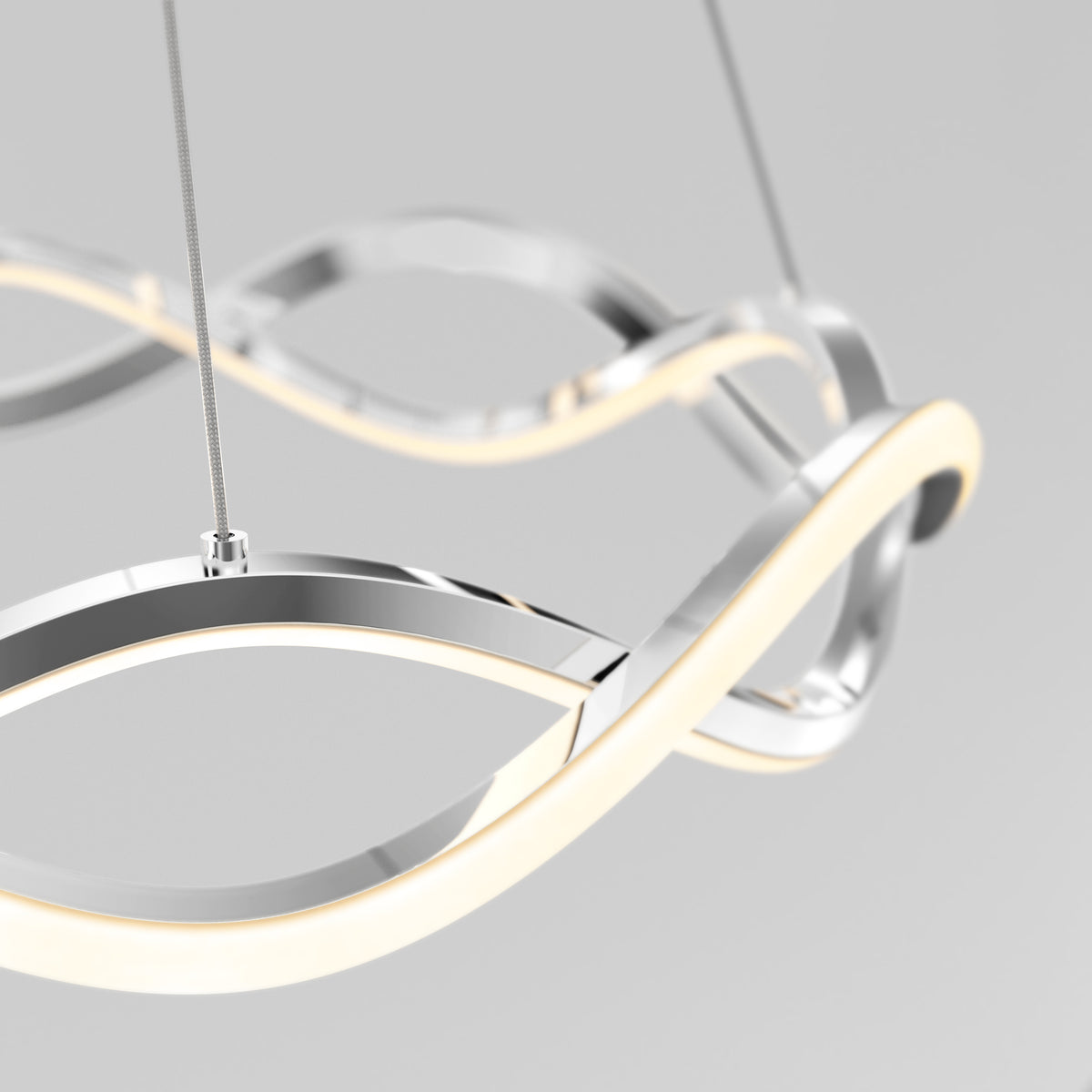 The Artika Vanora LED pendant light 5 CCT features smooth, sculptural metallic and illuminated loops, suspended by thin cables against a plain light gray background.