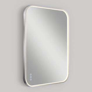 The Artika Royce Dimmable LED Mirror features rounded corners, adjustable 3 CCT lighting, three touch controls on the lower left, and illuminated edges for a modern look. Shown mounted horizontally against a plain gray background.