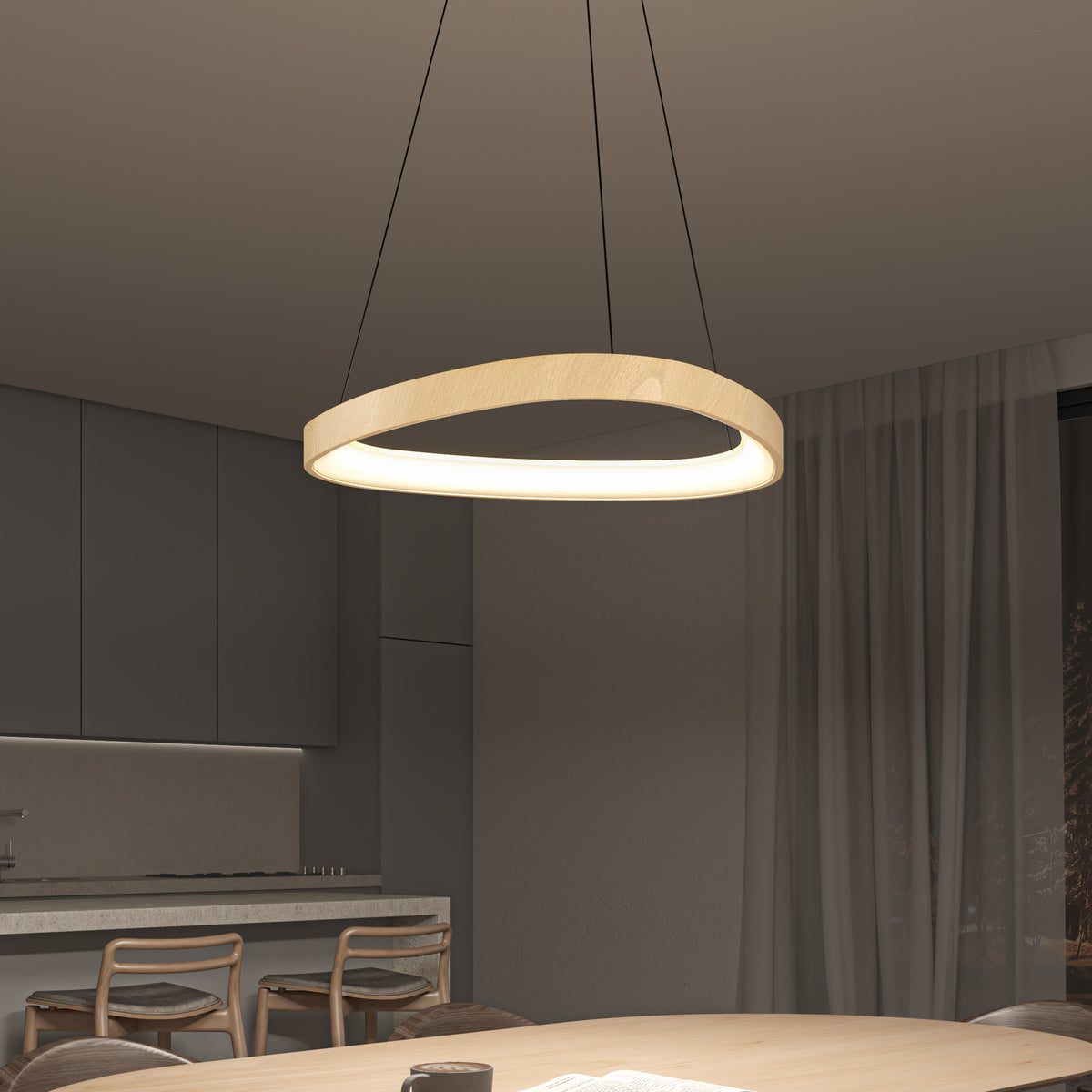 A modern, circular pendant light with a wooden finish hangs above a dining table in a contemporary kitchen and dining area with neutral tones, minimalist furniture, and sheer curtains.