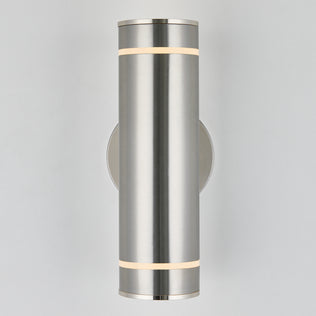 The Artika C7 indoor-outdoor wall light is a modern cylindrical brushed metal sconce, emitting soft white light from narrow top and bottom bands, mounted on a circular base against a plain light background.