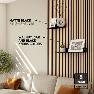 Living room with Artika Sonokit shelves & hooks on Sonolok/Sonofold panels, framed photo, plant & 5-year warranty badge.