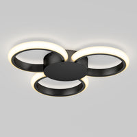 The Artika Nyala 15 in. LED flush mount light 5CCT features three interlocking black rings with glowing white LEDs, all mounted on a round black base and shown against a plain gray background.