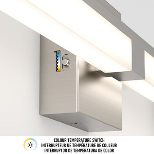 Close-up of the Artika Tivoli modern LED bathroom vanity light 5 CCT, showing its color temperature switch on a metallic fixture. Switch allows control of warmth. Text below: Colour temperature switch (English, French, Spanish).