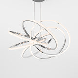 A modern ceiling light fixture with interlocking, illuminated rings in a chrome finish, suspended by thin cables against a plain white background.