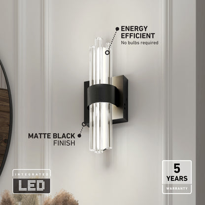The Artika Dorado LED contemporary wall sconce features clear glass rods, a matte black finish, and mounts on a white wall. It offers energy efficiency, 3 selectable CCTs, integrated LED (no bulbs needed), and a 5-year warranty.