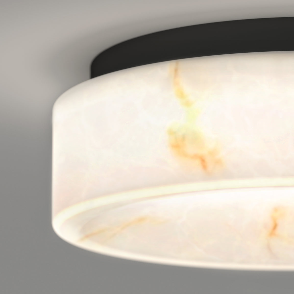 A close-up of the Artika Clifford 15 in. flush mount light, featuring a black base and frosted glass shade with subtle orange and yellow marbled patterns, offers versatile lighting with 5 selectable color temperatures.