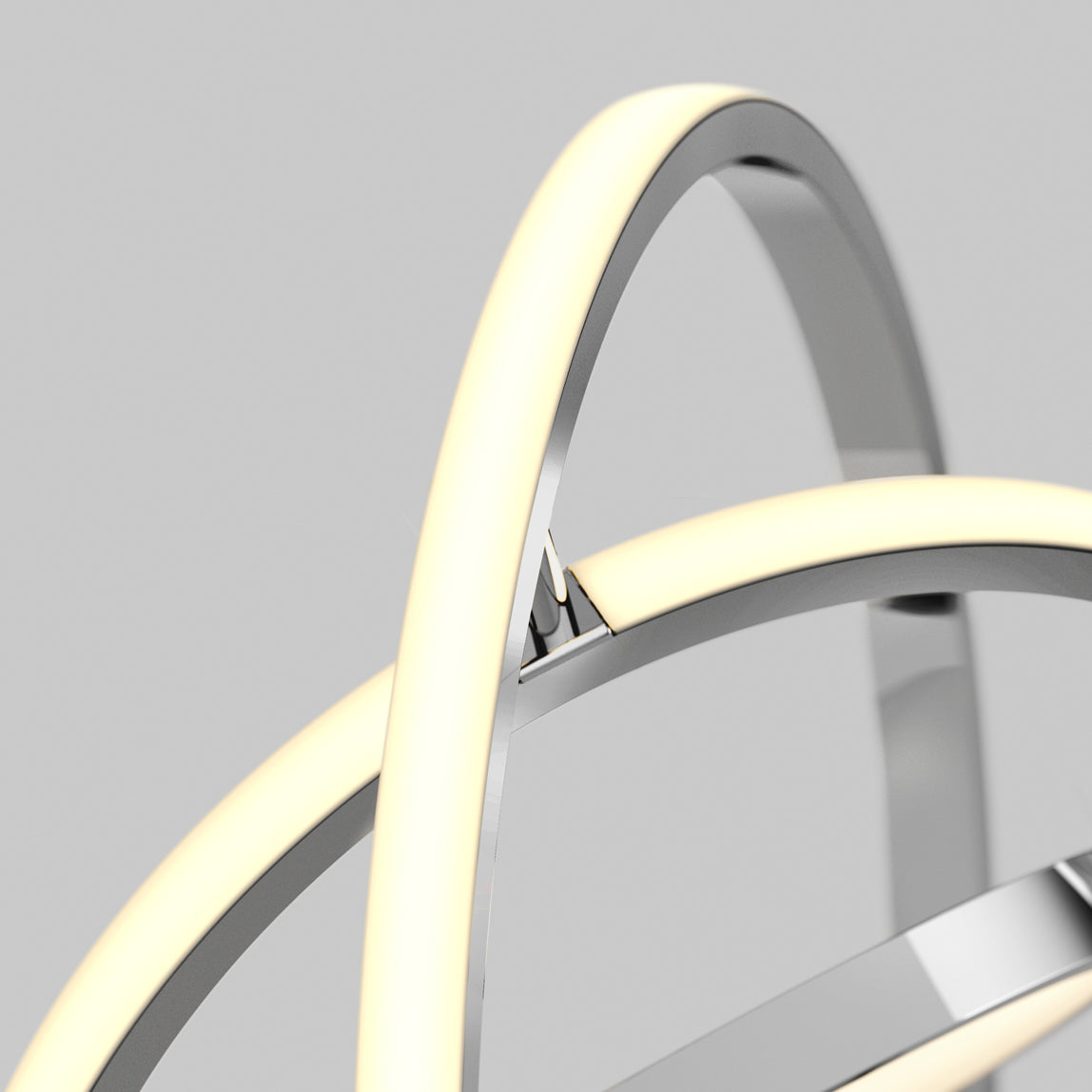 Close-up of the Artika Pivot modern LED floor lamp 3 CCT, featuring intersecting metallic rings and glowing curved LED strips against a plain gray background.