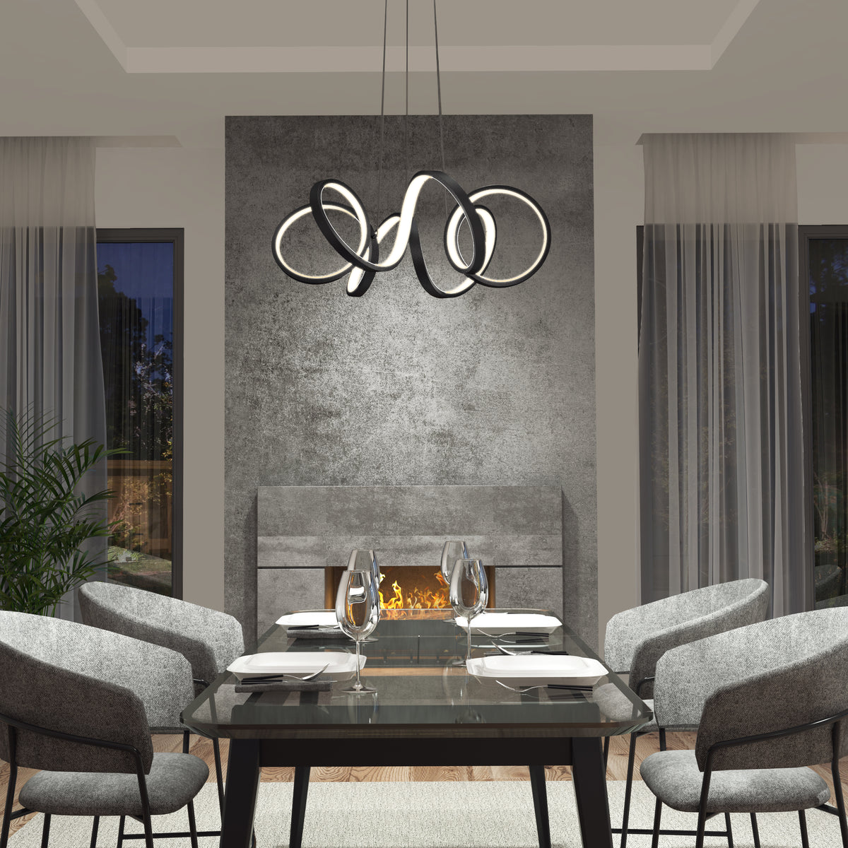 Modern dining room with a glass table set for four, gray chairs, a contemporary abstract chandelier, and a fireplace against a concrete-textured wall, with tall windows and sheer curtains on both sides.