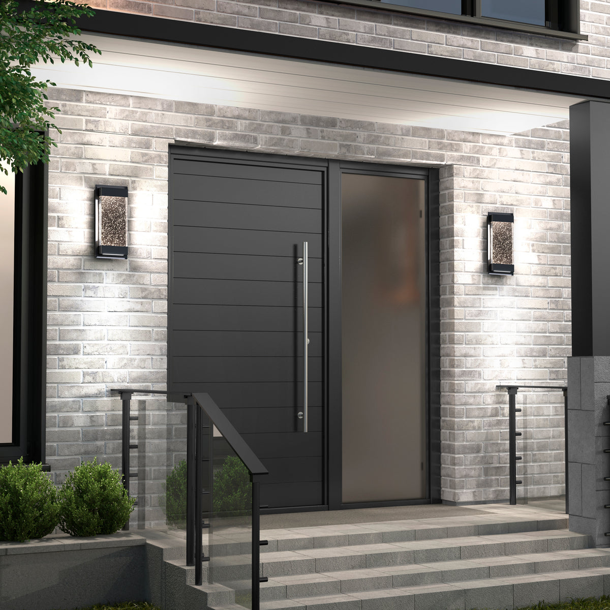 Modern front entrance with a large matte black door, vertical handle, frosted glass side panel, gray brick walls, steps with metal railings, and Artika Essence Glow Box indoor-outdoor LED wall lights on either side of the doorway.