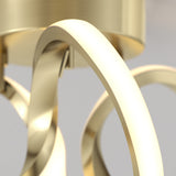 Close-up of a modern, gold-colored metallic light fixture with smooth, curved arms and a shiny surface, set against a neutral background.