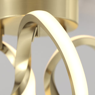 Close-up of the Artika Swirl LED flush mount—gold finish, curved arms—ideal for enhancing any modern interior.