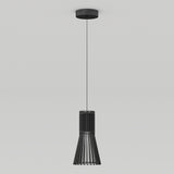 A modern black pendant light with vertical slats hangs from the ceiling by a thin cord against a plain white background.