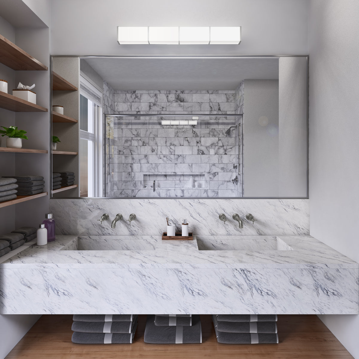 Modern bathroom with a large marble double sink, wall-mounted faucets, a wide mirror, and shelves with neatly stacked towels; shower area with marble tiles reflected in the mirror.