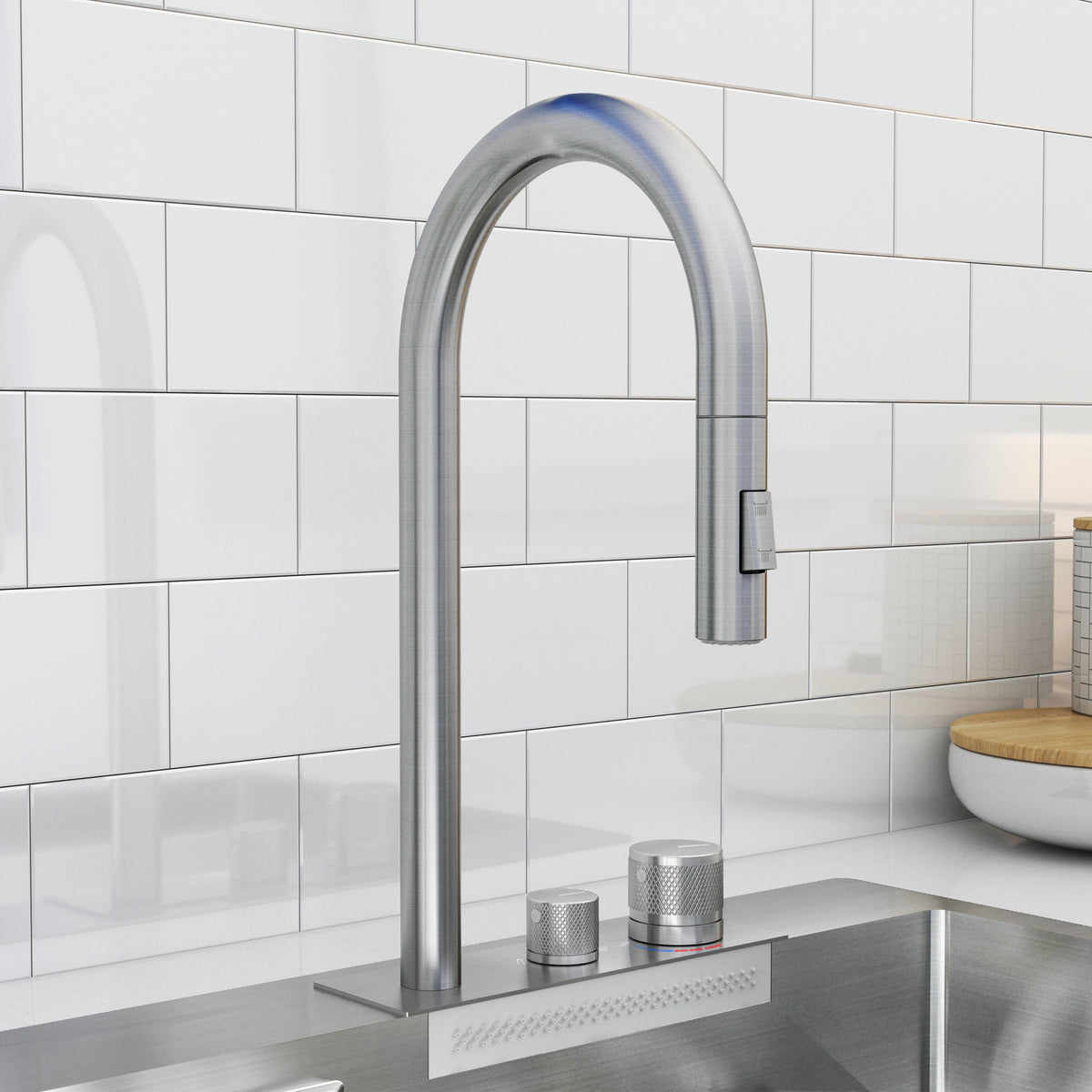 A modern stainless steel kitchen faucet with a high, curved spout and two round handles, set against a white tiled backsplash above a metal sink.