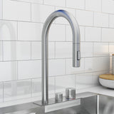 A modern stainless steel kitchen faucet with a high, curved spout and two round handles, set against a white tiled backsplash above a metal sink.