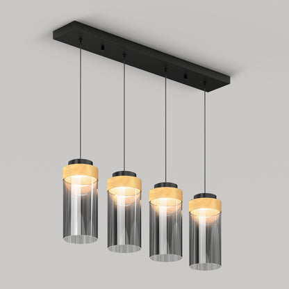 The Artika Hanson 4-light LED pendant features clear cylindrical glass shades with wooden accents, arranged in a row on a black rectangular ceiling mount. Visible bulbs add a modern touch to this stylish fixture.