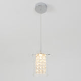 A modern pendant light with a chrome ceiling mount, a single wire suspending a cylindrical glass fixture filled with illuminated crystal elements, set against a plain white background.