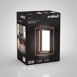 A black Artika product box featuring the Ghost LED wall-mounted light fixture, with images of the light in use, product details, and specs including 50,000-hour lifespan and 550 lumens.