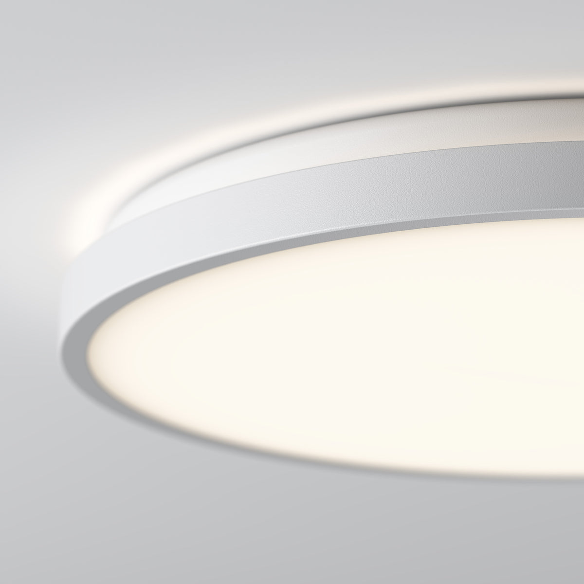 Close-up of Artika Isara 15 in. RGBIC LED Flush Mount glowing softly with interchangeable trim against a light gray background.