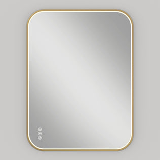 The Artika Royce Dimmable LED Mirror, featuring three CCT options, a gold frame with rounded corners, and touch controls, is mounted horizontally on a light gray wall.