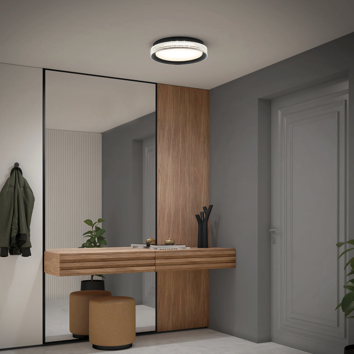 Modern entryway with a floating wooden console, two round beige stools, a large mirror, wall-mounted coat hook holding a green jacket, potted plant, and the Artika Aston 15 in. LED modern flush mount light 5 CCT on the ceiling.