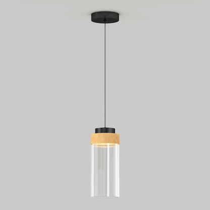 The Artika Hanson 1-light LED Pendant 5 CCT features a black ceiling mount, black cord, and a cylindrical glass shade with a wooden accent near the top, shown against a plain light gray background.