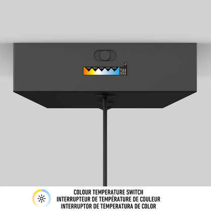 The Artika Barden 3-light LED pendant light in black mounts on the ceiling, featuring a color temperature switch (warm to cool) with scale. A cord hangs down, and multilingual info about the switch is displayed below.