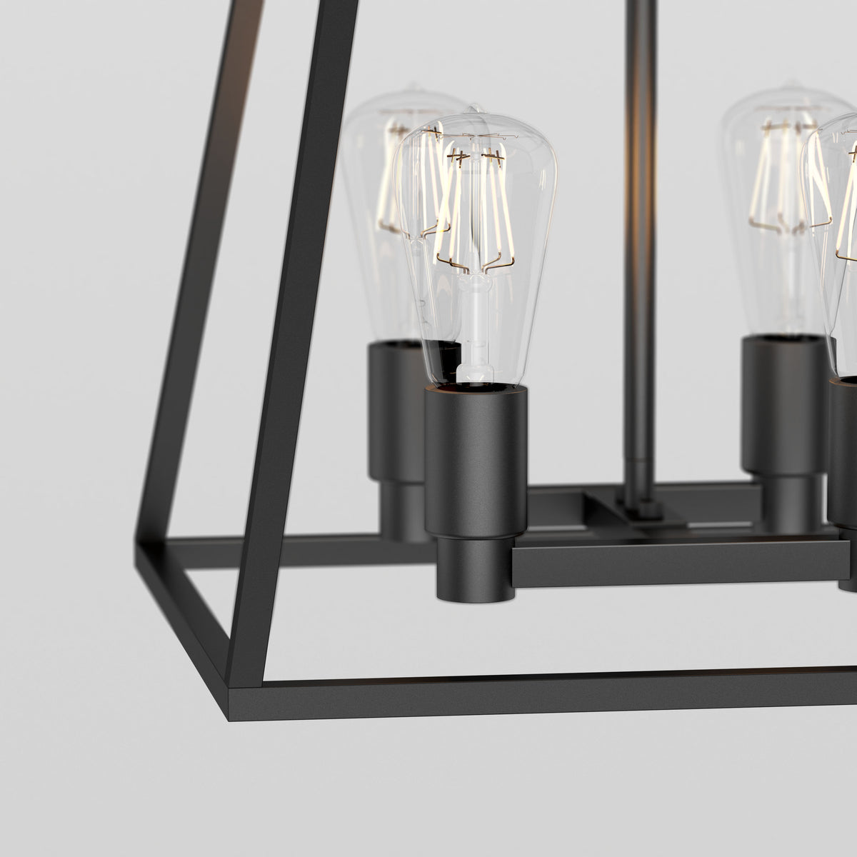 Close-up of the Artika Carter Square 4-light Chandelier, a modern black metal fixture with exposed Edison bulbs and a geometric rectangular frame, shown against a plain light gray background.