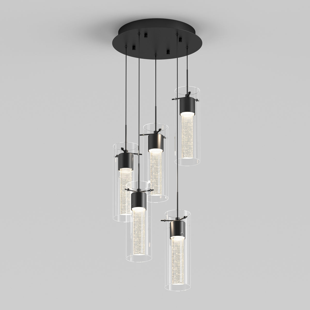 A modern ceiling light fixture with five cylindrical glass pendant lights hanging at different lengths from a round black base, each containing a sparkling, illuminated core.