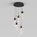 A modern ceiling light fixture with five cylindrical glass pendant lights hanging at different lengths from a round black base, each containing a sparkling, illuminated core.