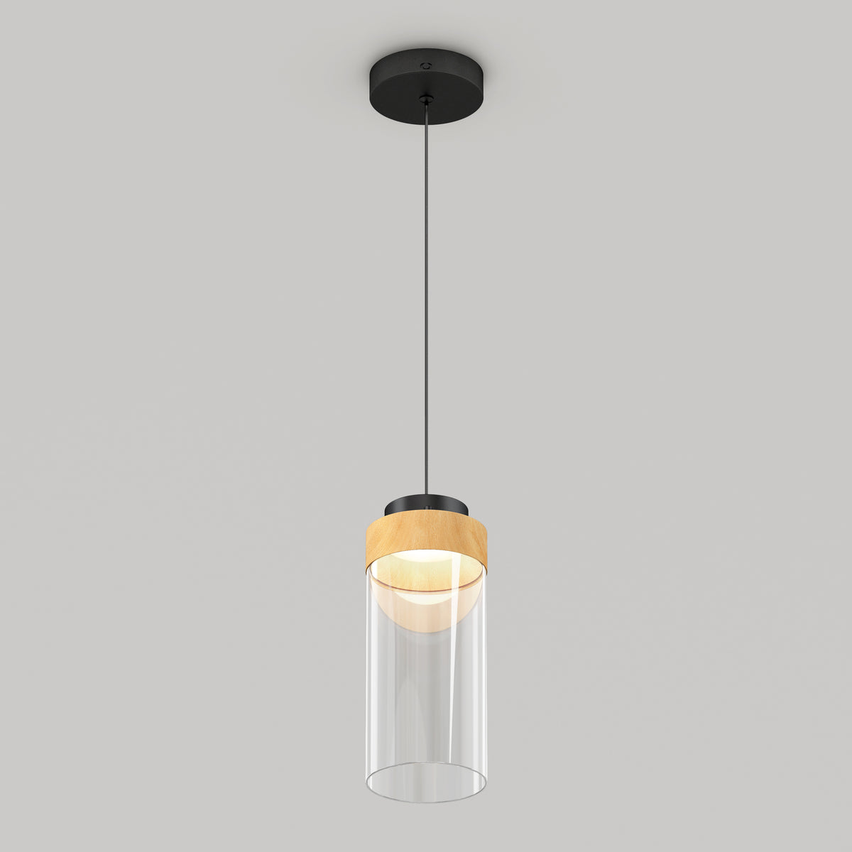 The Artika Hanson 1-light LED pendant features a black ceiling mount, black cord, wooden accent, and cylindrical clear glass shade, shown against a plain light gray background.