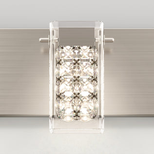 The Artika Crystal Cube LED bathroom vanity light 5 CCT is a modern wall sconce with a rectangular clear glass shade featuring faceted crystal-like accents, mounted on a brushed metal backplate and illuminated from within.
