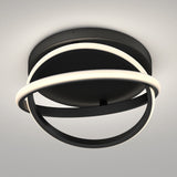 A modern ceiling light fixture with two intersecting black rings, each partially illuminated by integrated LED strips, mounted on a round black base against a light-colored ceiling.