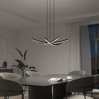 Modern dining room with a rectangular table, four upholstered chairs, a plant, and the Orly modern LED pendant light by Artika. An open magazine and a cup sit on the table; beyond the window, the night sky is visible.