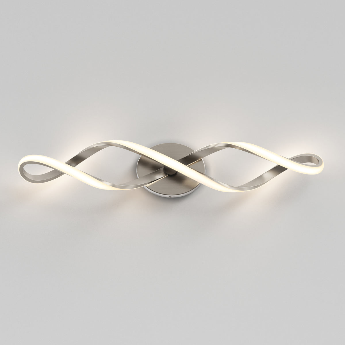 The Artika Swirl LED bathroom vanity light features two intertwined, wave-shaped arms on a round metallic base, emitting a soft white glow.