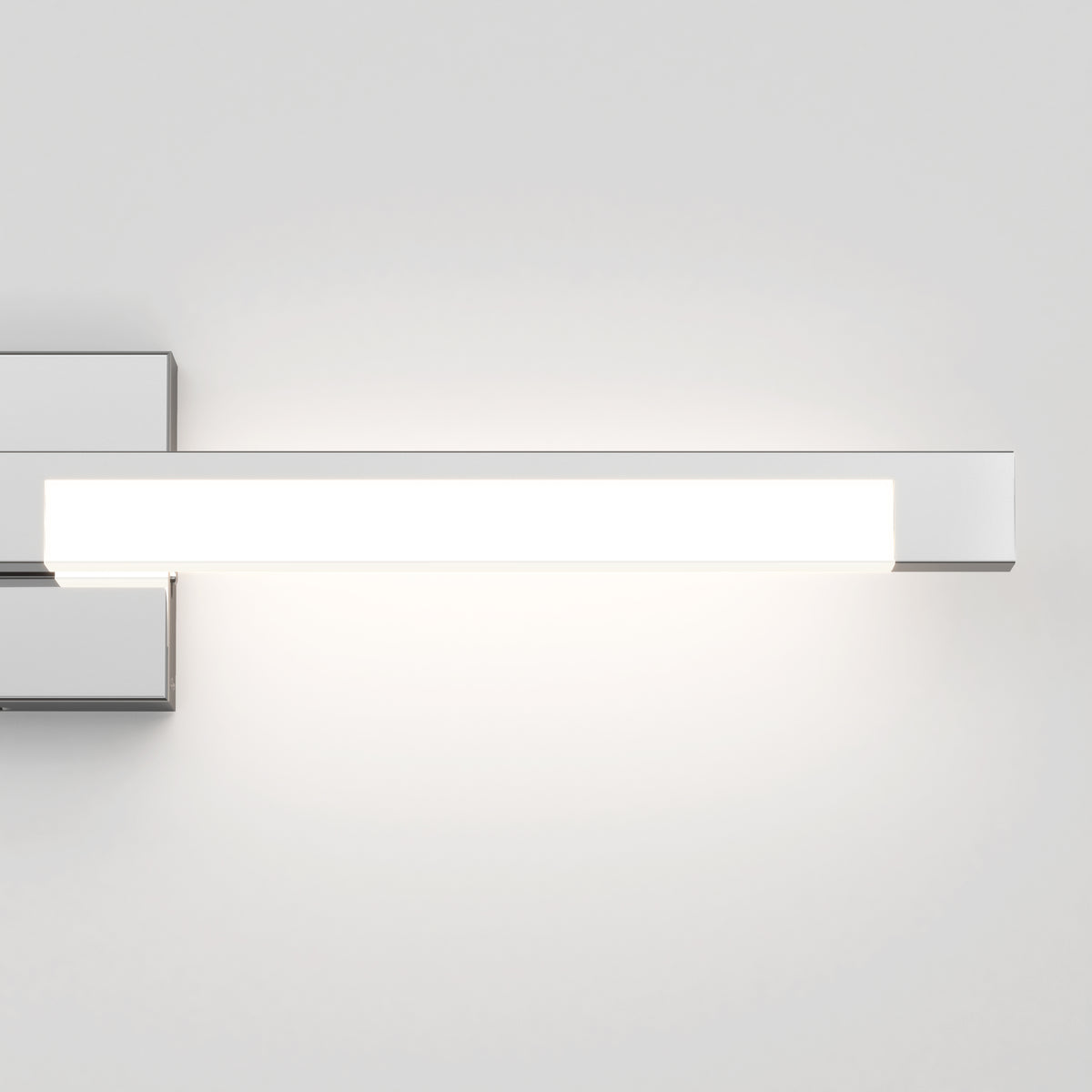 The Artika Tivoli modern LED bathroom vanity light 5 CCT, a sleek rectangular wall fixture with a chrome finish, is mounted on a white wall and features adjustable lighting for customizable ambiance.
