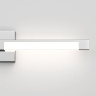 The Artika Tivoli modern LED bathroom vanity light 5 CCT, a sleek rectangular wall fixture with a chrome finish, is mounted on a white wall and features adjustable lighting for customizable ambiance.
