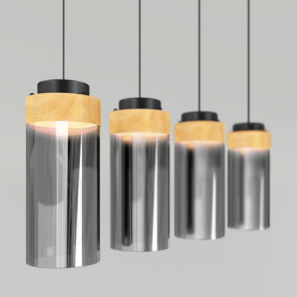 The Artika Hanson 4-light LED pendant features cylindrical glass shades, wooden accents, and black cords arranged in a row against a gray background.