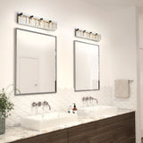 Modern bathroom with two rectangular mirrors above dual sinks, marble countertop, sleek wall-mounted faucets, scalloped white tile backsplash, wooden cabinetry, and decorative light fixtures above each mirror.