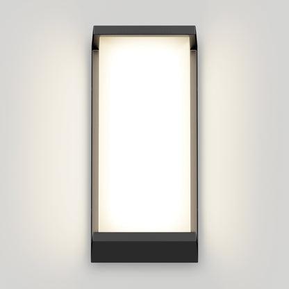 The Artika Faro modern LED indoor-outdoor wall light 3 CCT features a black rectangular frame and evenly diffuses a soft white glow, accentuating its minimalist design on a light gray wall.