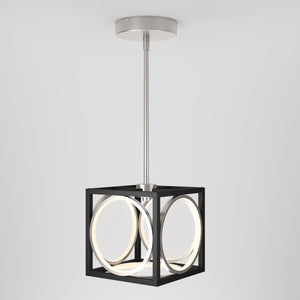 The Artika Astoria LED modern pendant light features a silver ceiling mount, straight rod, and black cube frame with suspended circular LED lights, highlighting its geometric style against a plain white background.